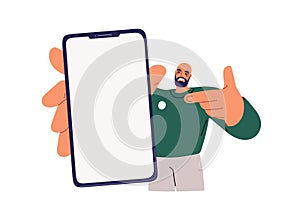 Showing mobile phone screen in hand. Happy man holding smartphone mockup, advertising cellphone app. Guy pointing at