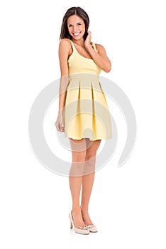 Showing off her gorgeous legs in a summer dress. Full-length studio portrait of a beautiful young woman posing in a