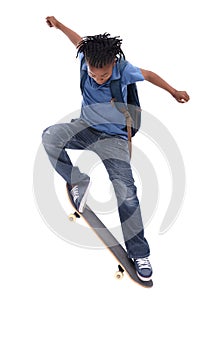 Showing off his mad skills. A young African-American boy doing a trick on his skateboard.