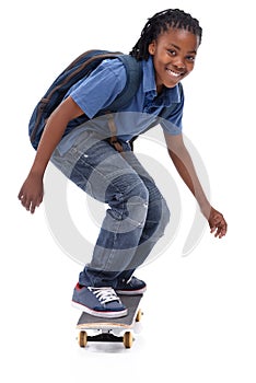 Showing off his mad skills. A young African-American boy doing a trick on his skateboard.