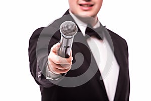 The Showman interviewer. Young elegant man holding microphone
