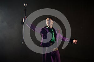 Showman. Young male entertainer, presenter or actor on stage. The guy in the purple camisole and the cylinder.