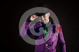 Showman. Young male entertainer, presenter or actor on stage. The guy in the purple camisole and the cylinder.