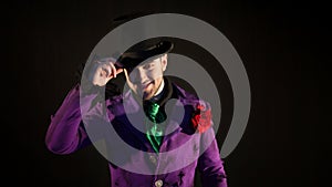 Showman. Young male entertainer, presenter or actor on stage. The guy in the purple camisole and the cylinder.