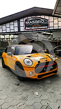 showroom car yellow mini cooper.