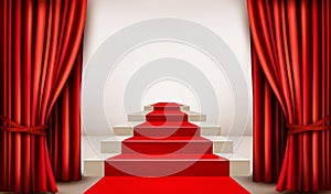 Showroom with red carpet leading to a podium with curtains.