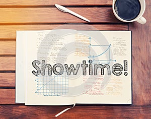 Showtime : text inside notebook on table with coffee