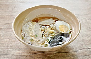 shoyu ramen or Japanese yellow noodles topping slice braised pork and boiled egg in soy sauce soup on bowl