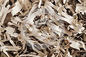 Shredded brown paper packing material close up. Eco friendly recycled paper filling for gift boxes