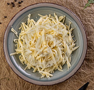 Shredded cheese waiting in a plate