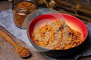 Shredded chicken served in a glass jar and read bowl