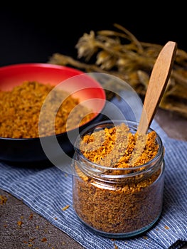 Shredded chicken served in a glass jar and read bowl