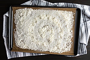 Shredded Coconut on a Parchment Lined Sheet Pan