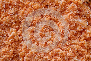 Shredded fresh carrots after juicer, close up, top view