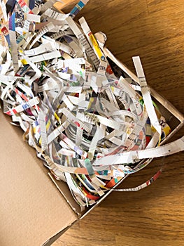 shredded paper documents newspaper inside cardboard box