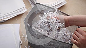 Shredded private confidential documents. Shredded paper in a shredder container