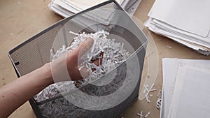 Shredded private confidential documents. Shredded paper in a shredder container