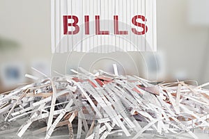 Shredded red BILLS letters above Cut up credit cards on Shredded Bills and Bank Statements