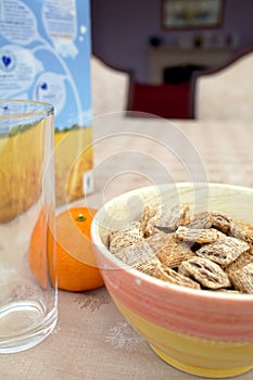 Shredded wheat cereal and orange