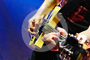 Shredding Frets: Electric Guitar Played on Stage