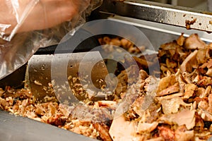 Shredding meat in a fast food kitchen for shawarma, fried chicken.