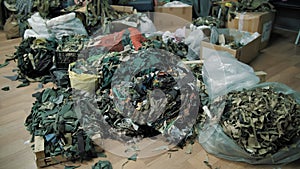 shreds of camouflage fabric. many cut ribbons of khaki or green fabric. volunteer center, organization for weaving