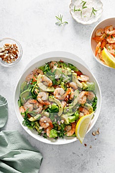 Shrimp avocado salad with lettuce and arugula, top view