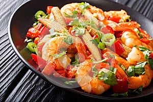 Shrimp with bell pepper, chili, garlic, corn cob and herbs close