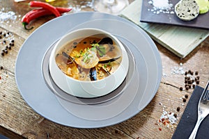 Shrimp Bisque with Seafood. King prawn, blue mussels, cod, whipped cream. Delicious traditional food closeup served for