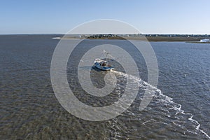 A shrimp boat pulls nets off the coast of South Carolina in this aerial view