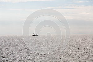 Shrimp Boat Sillouette Pulling Net photo