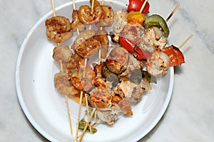 Shrimp and chicken skewer or mix kebab close and cropped view.