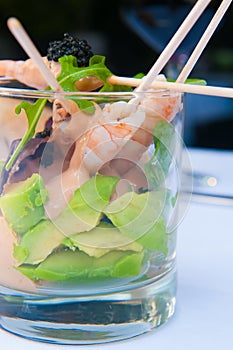 Shrimp cocktail in a glass with letouce