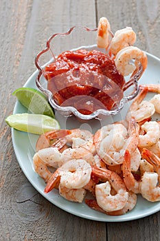 Shrimp Cocktail with sauce and lime wedges