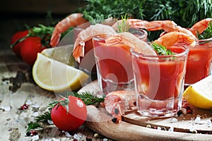 Shrimp cocktail in small glasses, cherry tomatoes, dill, parsley