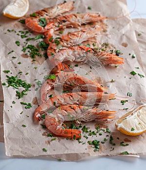 Shrimp cooked with lemon and parsley on paper