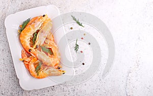 Shrimp and dill in white plate