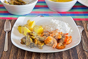 Shrimp dish with rice and vegetables on a plate.