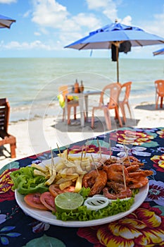 Shrimp dish served at a beach bar on Coroa do Aviao islet, popular destination on the north coast of Pernambuco state