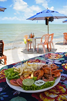 Shrimp dish served at a beach bar on Coroa do Aviao islet, popular destination on the north coast of Pernambuco state photo