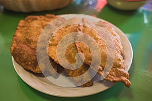 Shrimp empanadas with cheese, accompanied by dressing