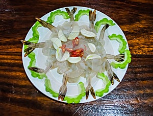 Shrimp in fish sauce with gour on hardwood table..