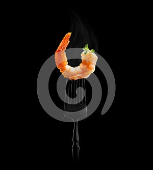 Shrimp on a fork. Black background