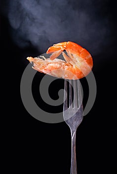 Shrimp on the fork with black background