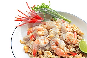 Shrimp fried rice. stir fried rice with shrimp decorate flowers from red chilly peppers and lime.