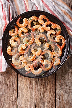 Shrimp in garlic sauce with parmesan cheese and herbs in a pan c