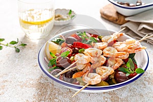 Shrimp kebab roasted on skewers and fresh vegetable salad