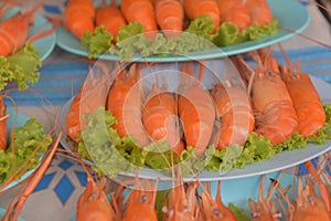 Shrimp and leaves of saat on plates in the night market,