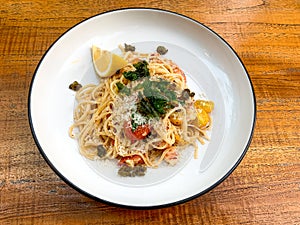 Shrimp linguine, green garnish, cherry tomatoes, grated parmesan