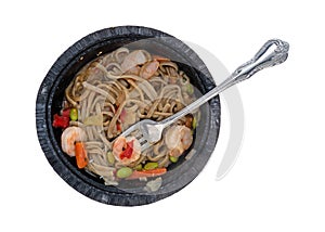 Shrimp with noodles and vegetables with a fork in a tray